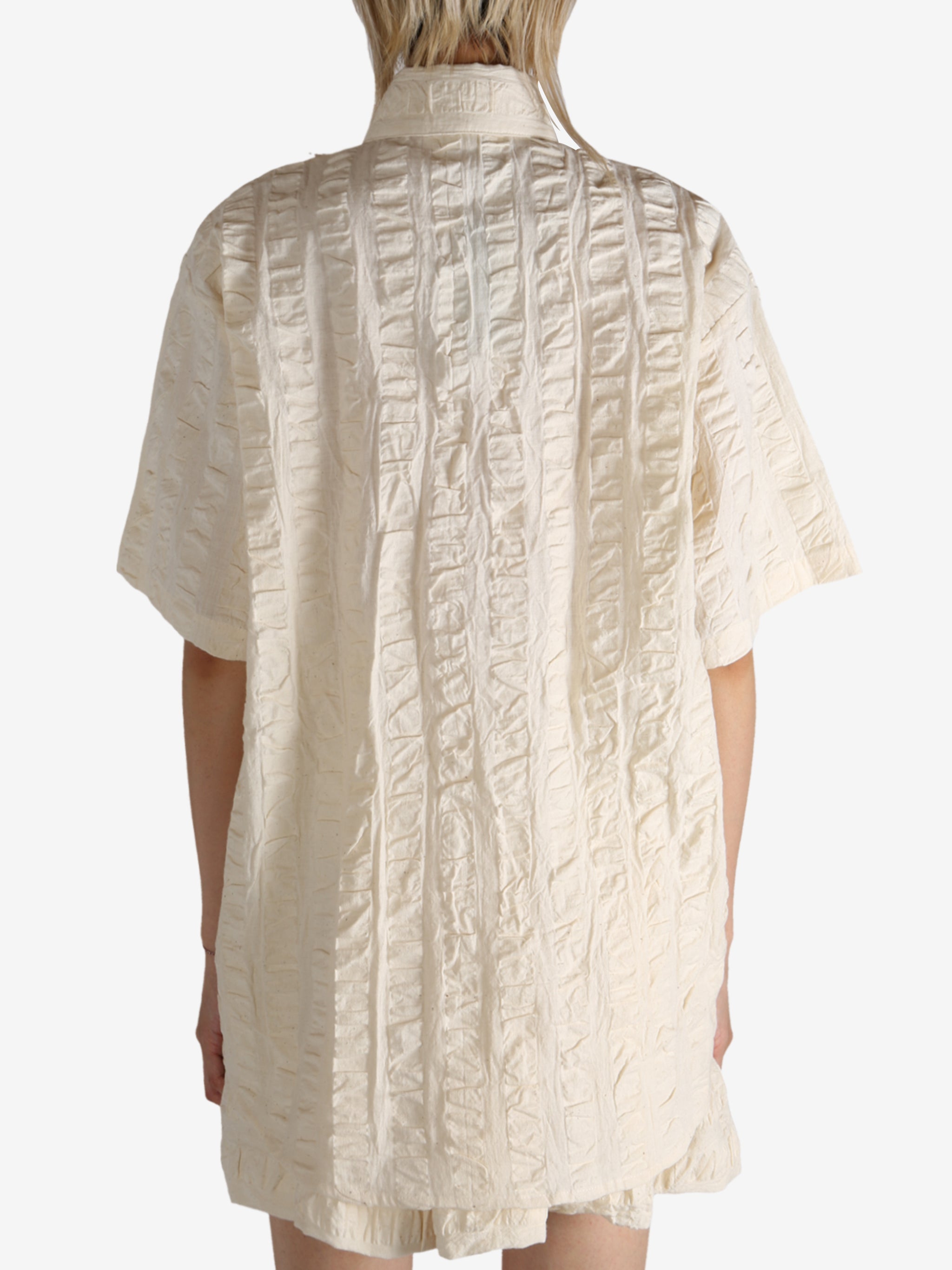 White shirt worn by a person, showing the shirt's fit