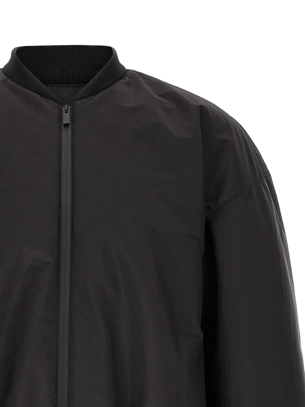 Close up of Black jacket, showing texture of the polyester fabric
