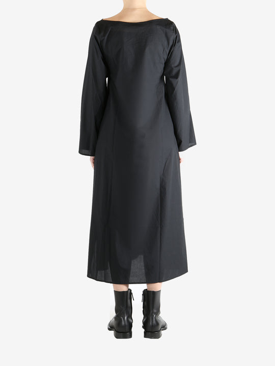 Black dresses worn by a person, showing the dresses fit