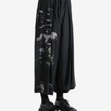 Black pants worn by a person, showing the pants fit