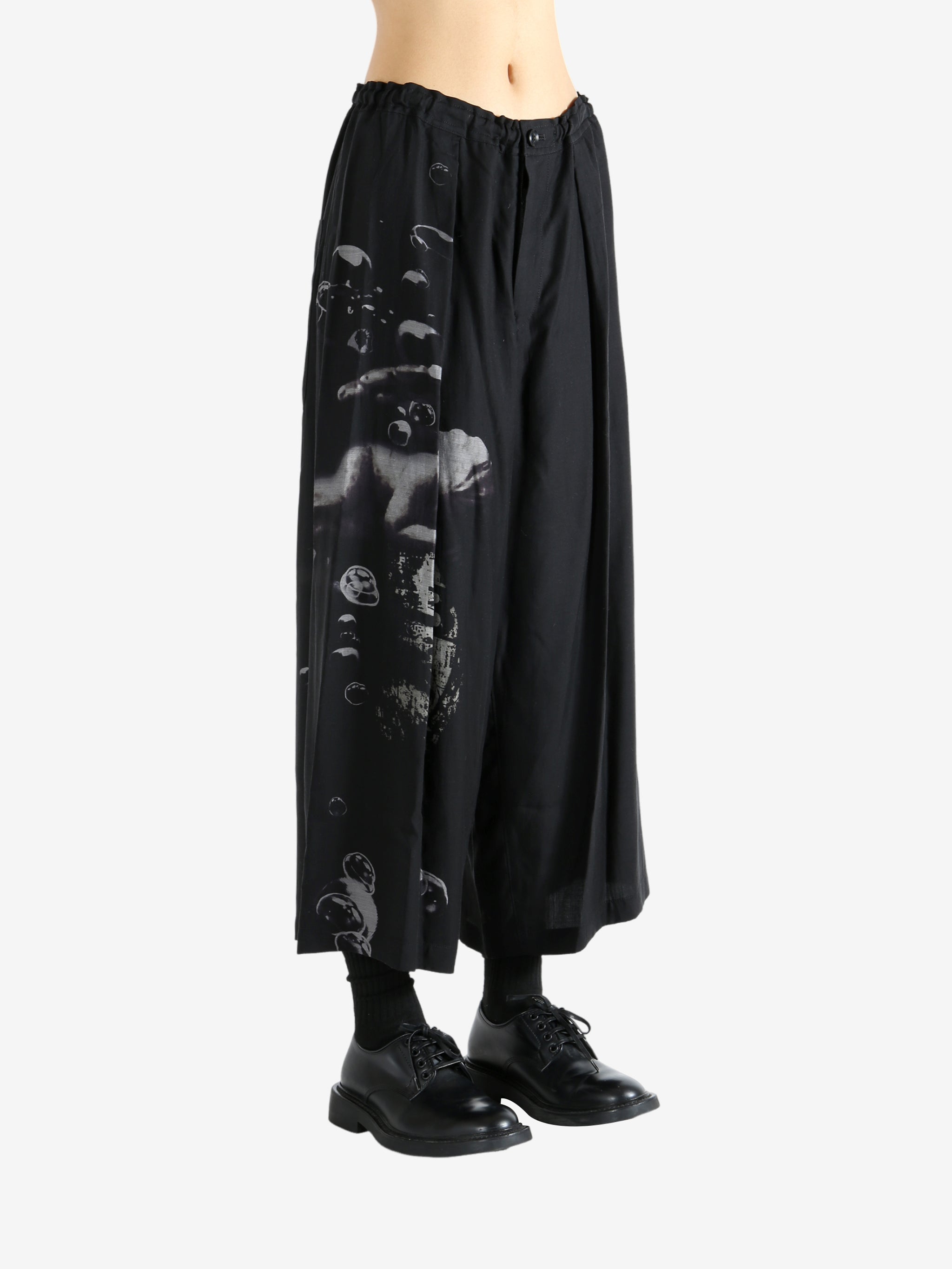 Black pants worn by a person, showing the pants fit