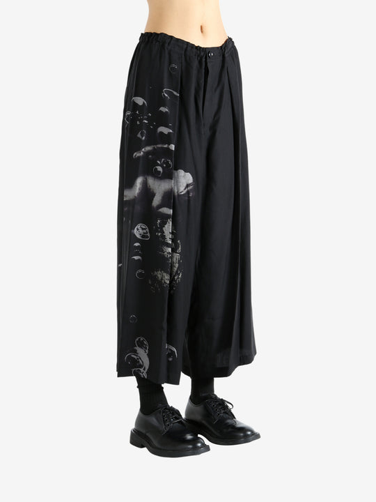 Black pants worn by a person, showing the pants fit