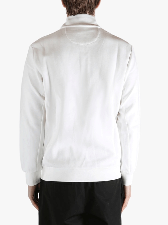 White pullover worn by a person, showing the pullover's fit