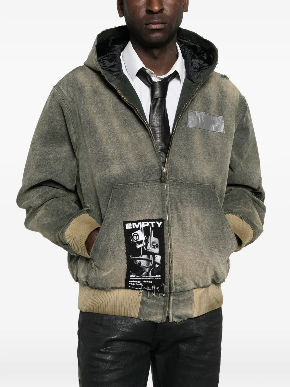 Green jacket worn by a person, showing the jacket fit