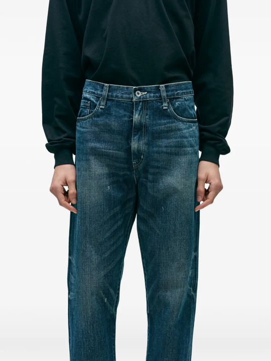 Blue pants worn by a person, showing the pants fit