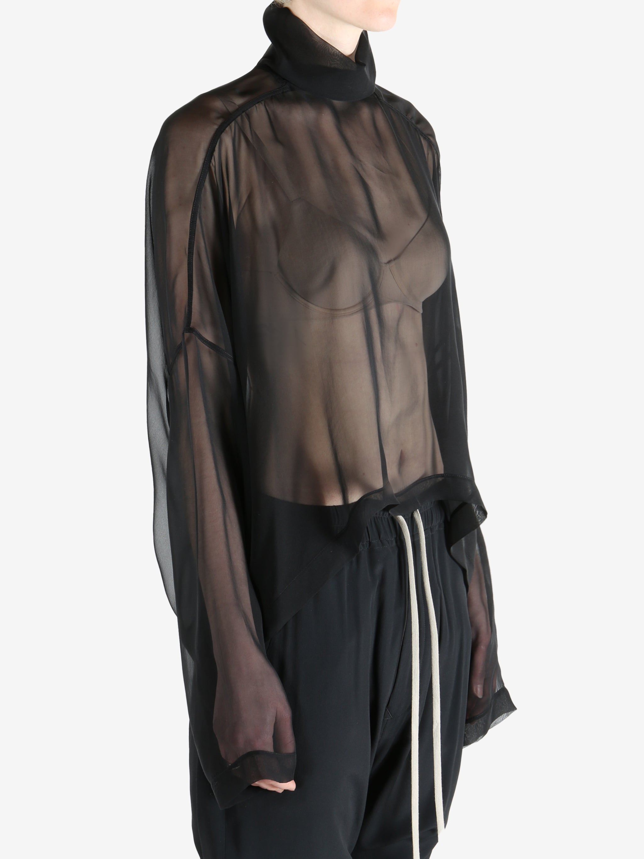 Black top worn by a person, showing the top's fit