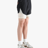 Black pants worn by a person, showing the pants's fit