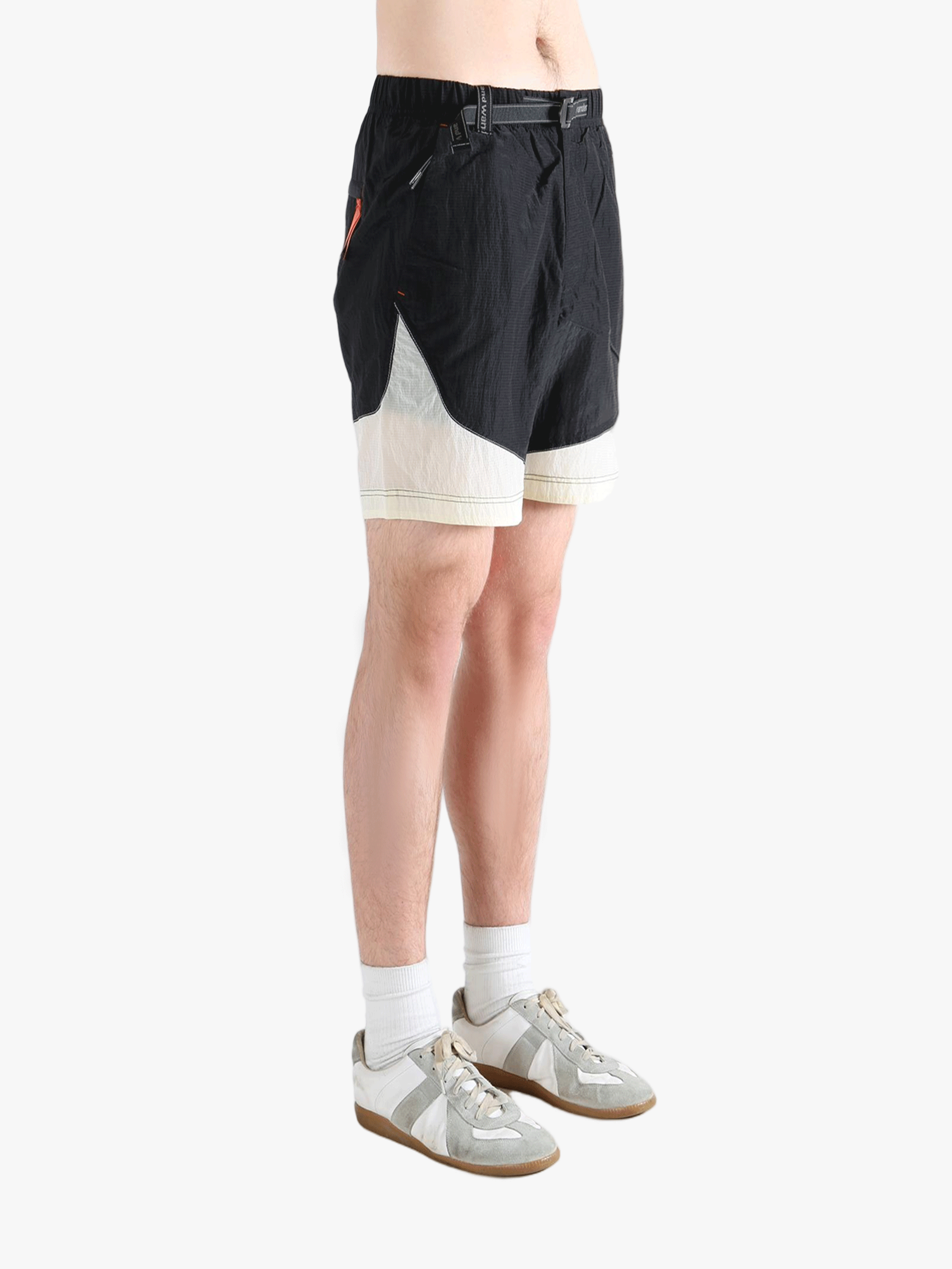 Black pants worn by a person, showing the pants's fit