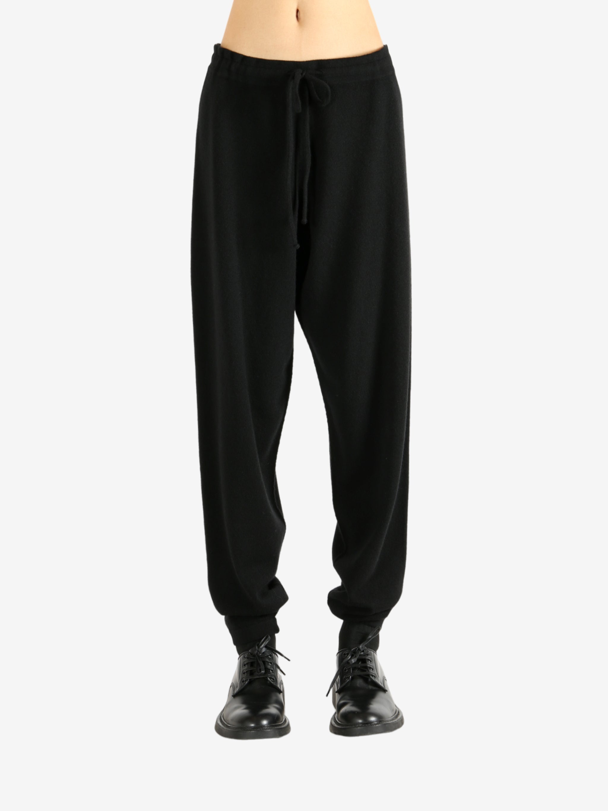 Black pants worn by a person, showing the pants' fit