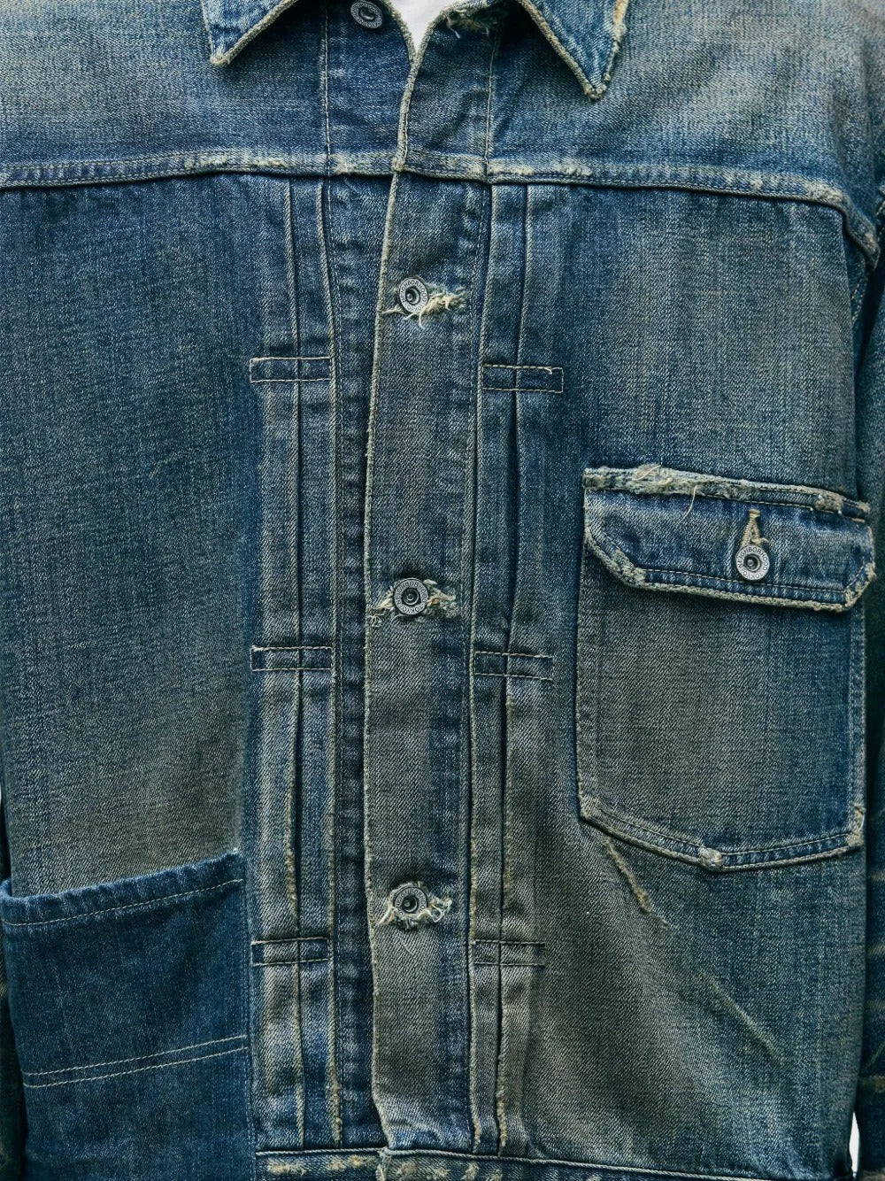 Close up of blue jacket, showing texture of the cotton fabric