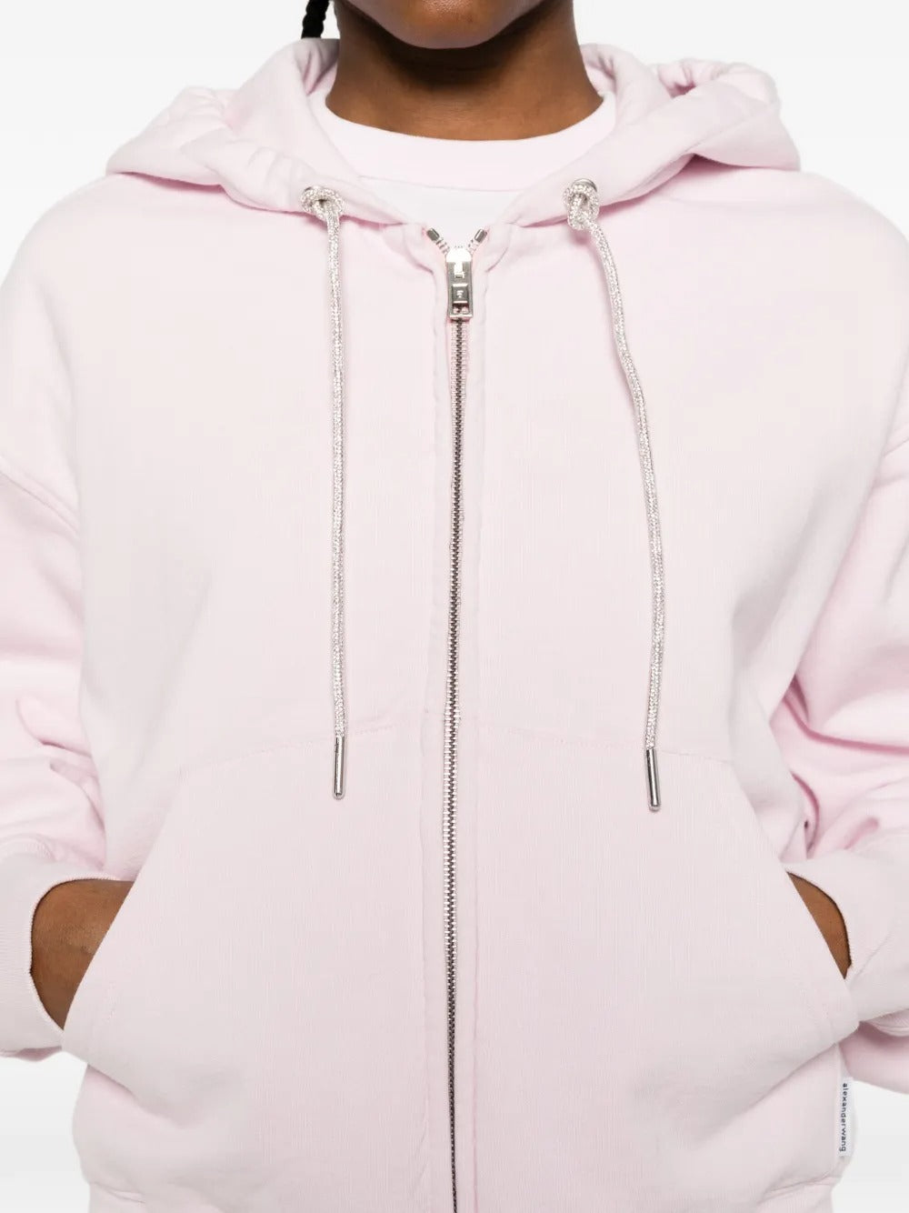  Close up of pink hoodie, showing texture of the cotton fabric
