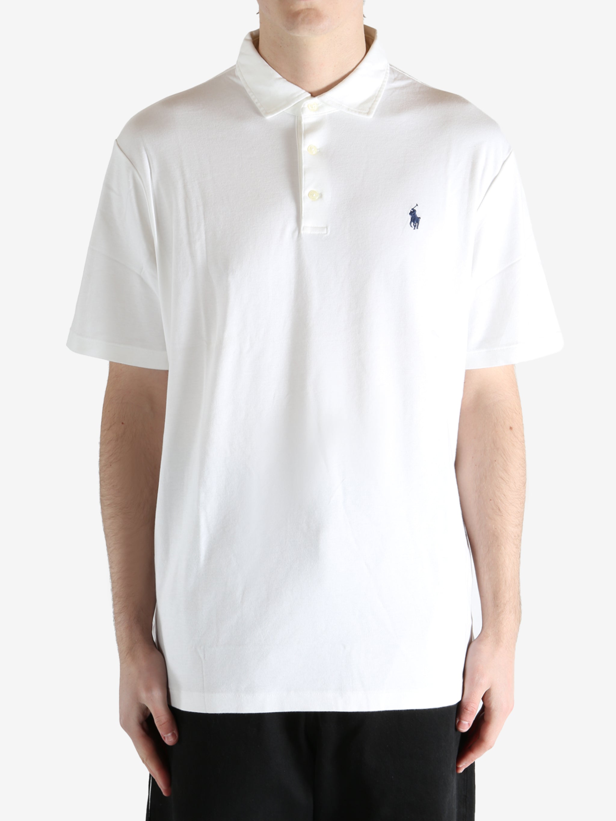 White t-shirt worn by a person, showing the shirt's fit