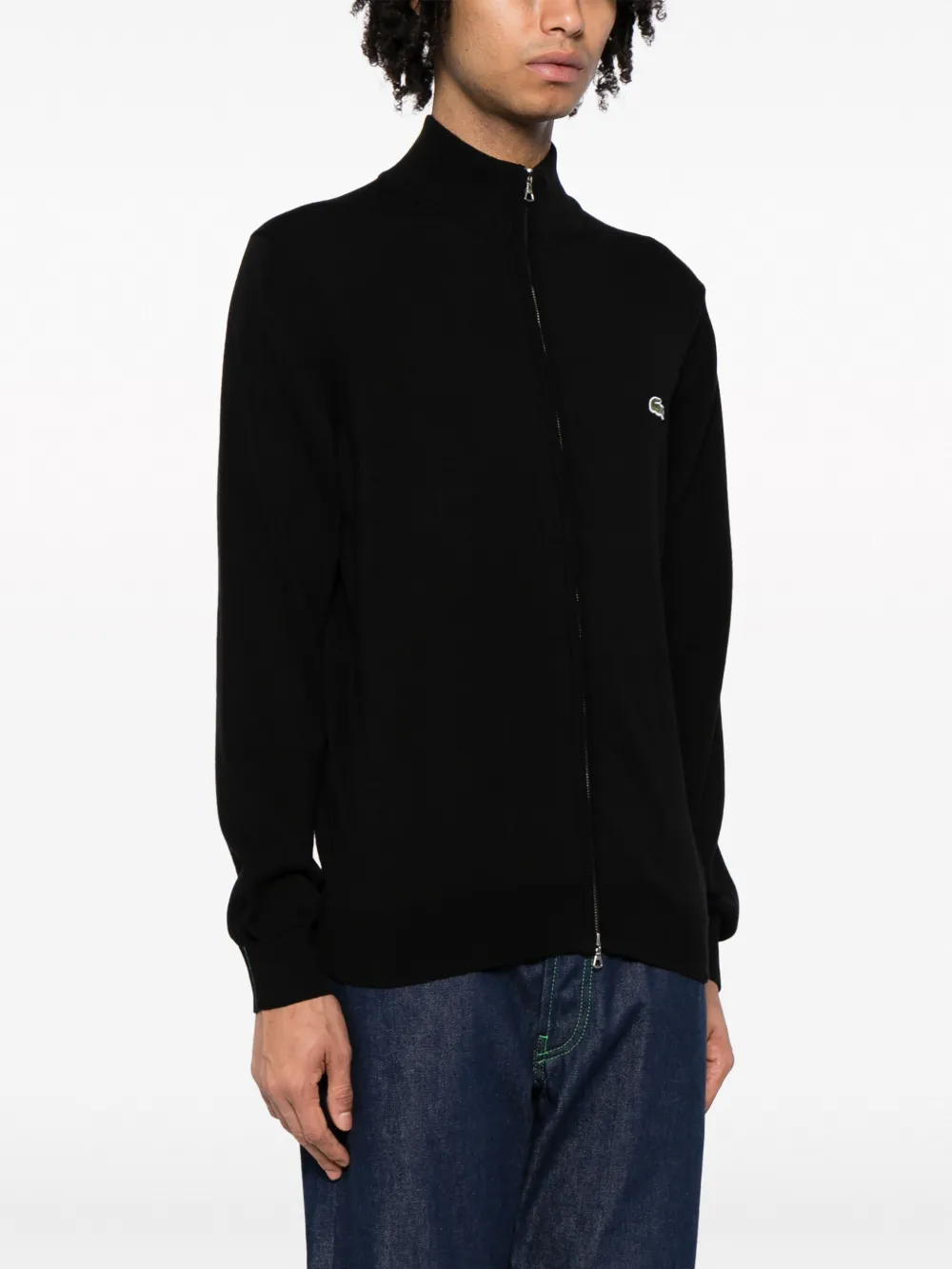 Black sweater worn by a person, showing the sweater fit