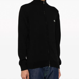 Black sweater worn by a person, showing the sweater fit