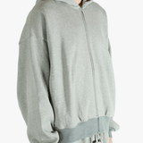 Gray zip-up hoodie worn by a person, showing the hoodie fit