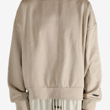 Tan hoodies worn by a person, showing the hoodies fit