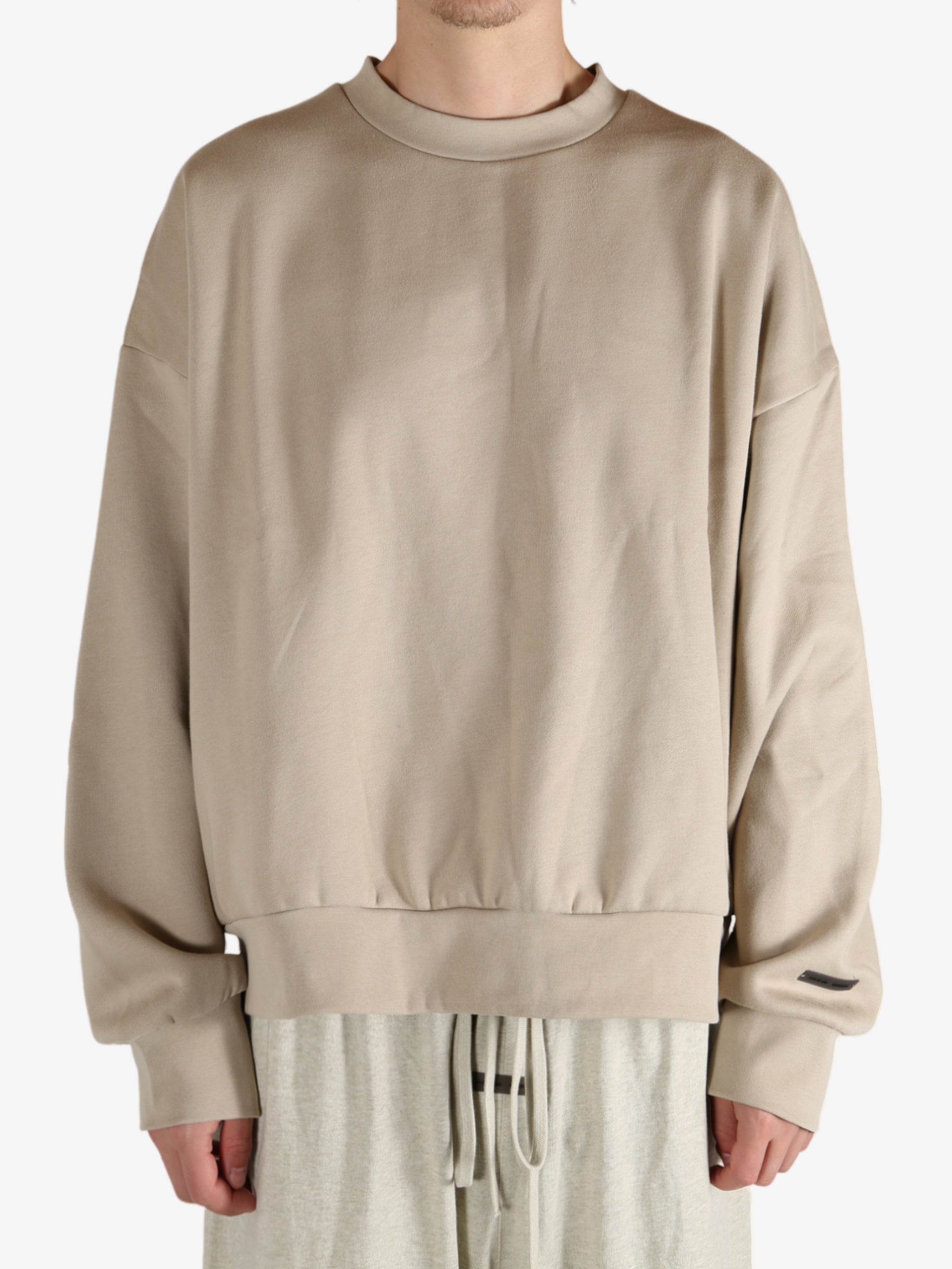 Tan hoodies worn by a person, showing the hoodies fit