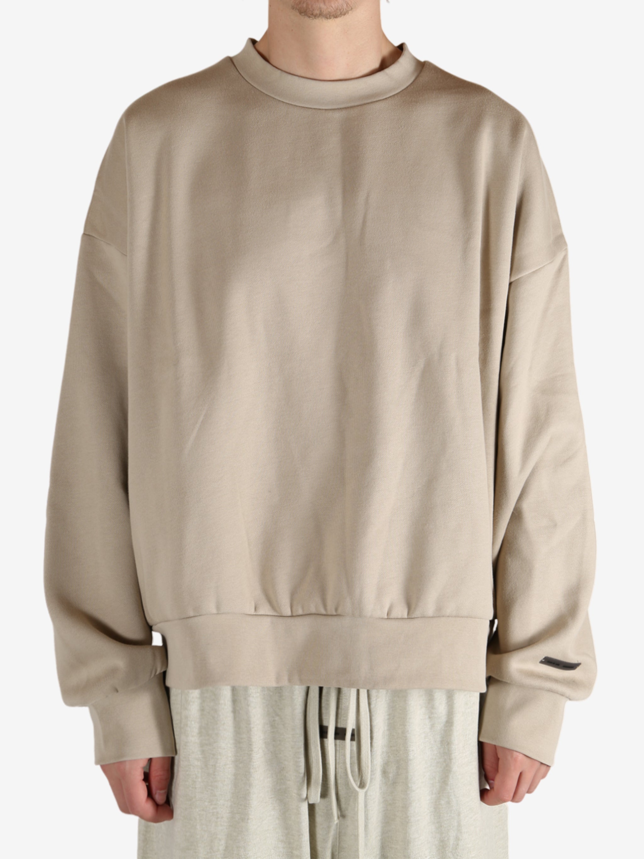 Tan hoodies worn by a person, showing the hoodies fit