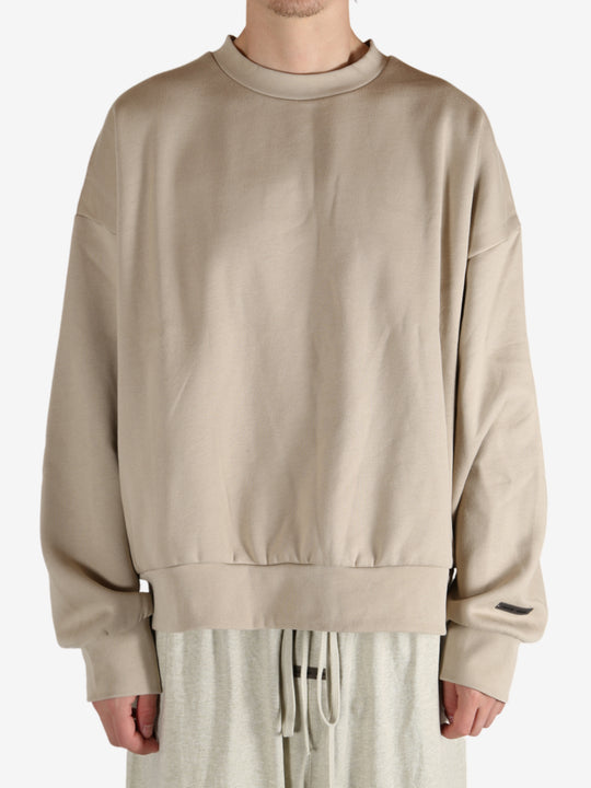 Tan hoodies worn by a person, showing the hoodies fit