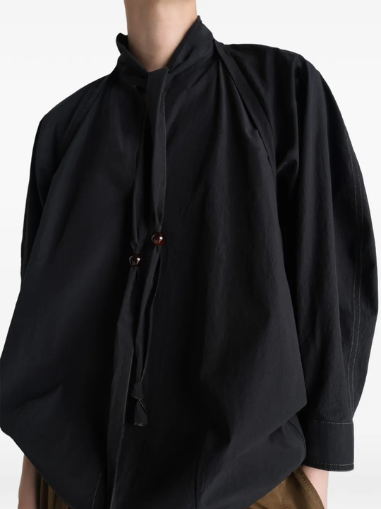 Close up of black top, showing texture of the cotton fabric