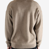 Brown knitwear worn by a person, showing the knitwear's fit