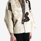 Tan coat worn by a person, showing the coat fit