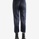 Navy pleated pants  worn by a person, showing the pants fit