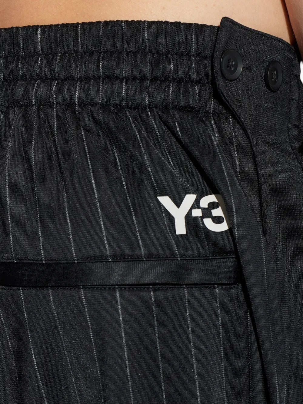 Close up of black pants, showing texture of the recycled polyester fabric