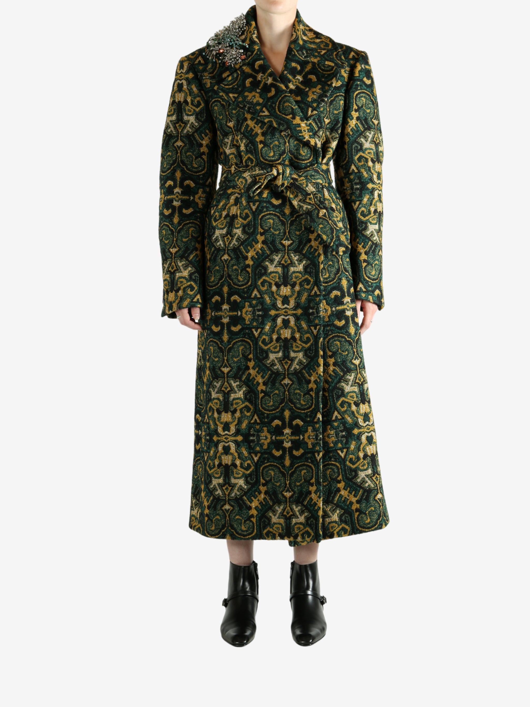 Green coat worn by a person, showing the coat's fit