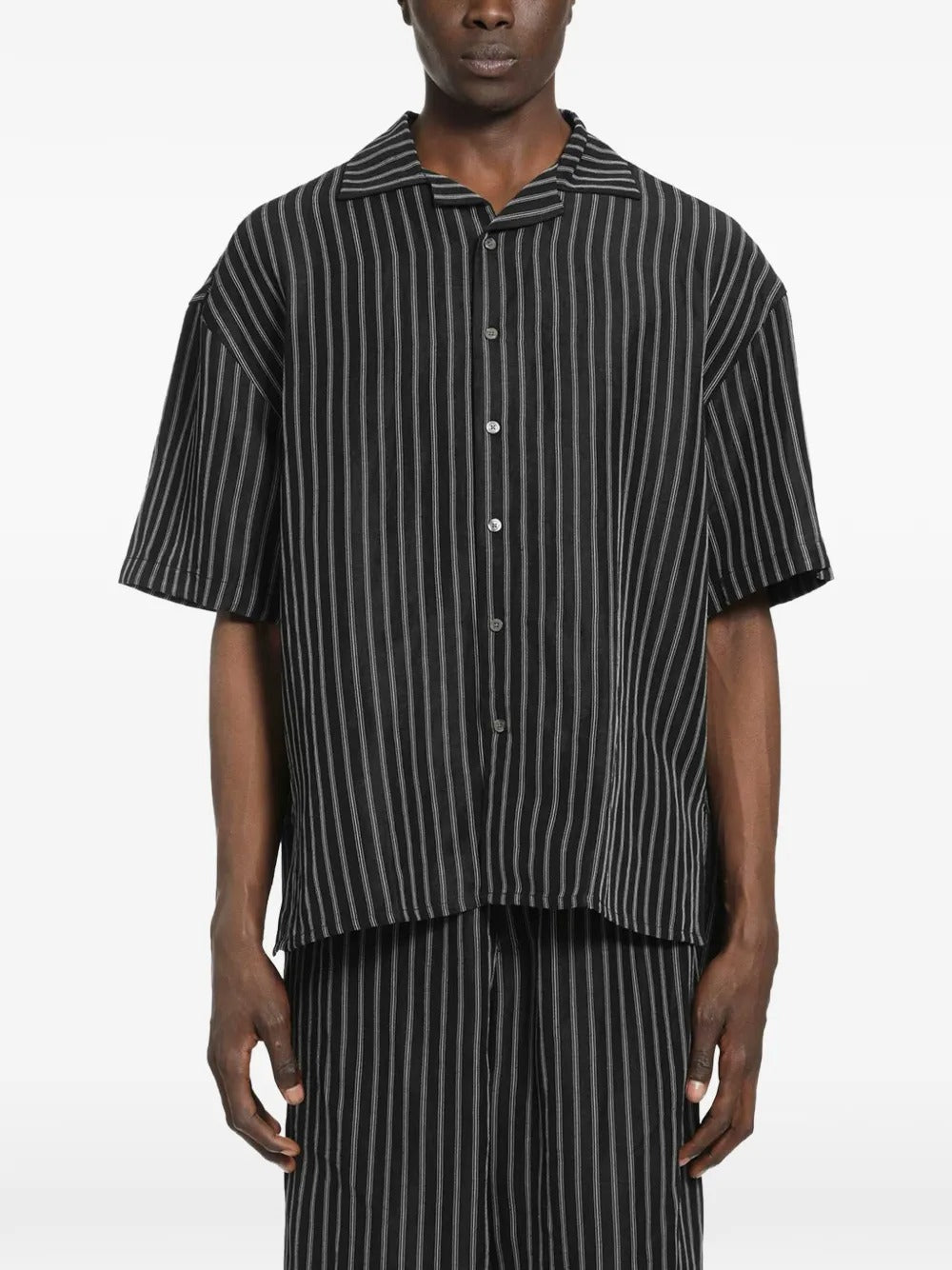 Black shirt worn by a person, showing the shirt's fit