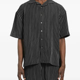 Black shirt worn by a person, showing the shirt's fit