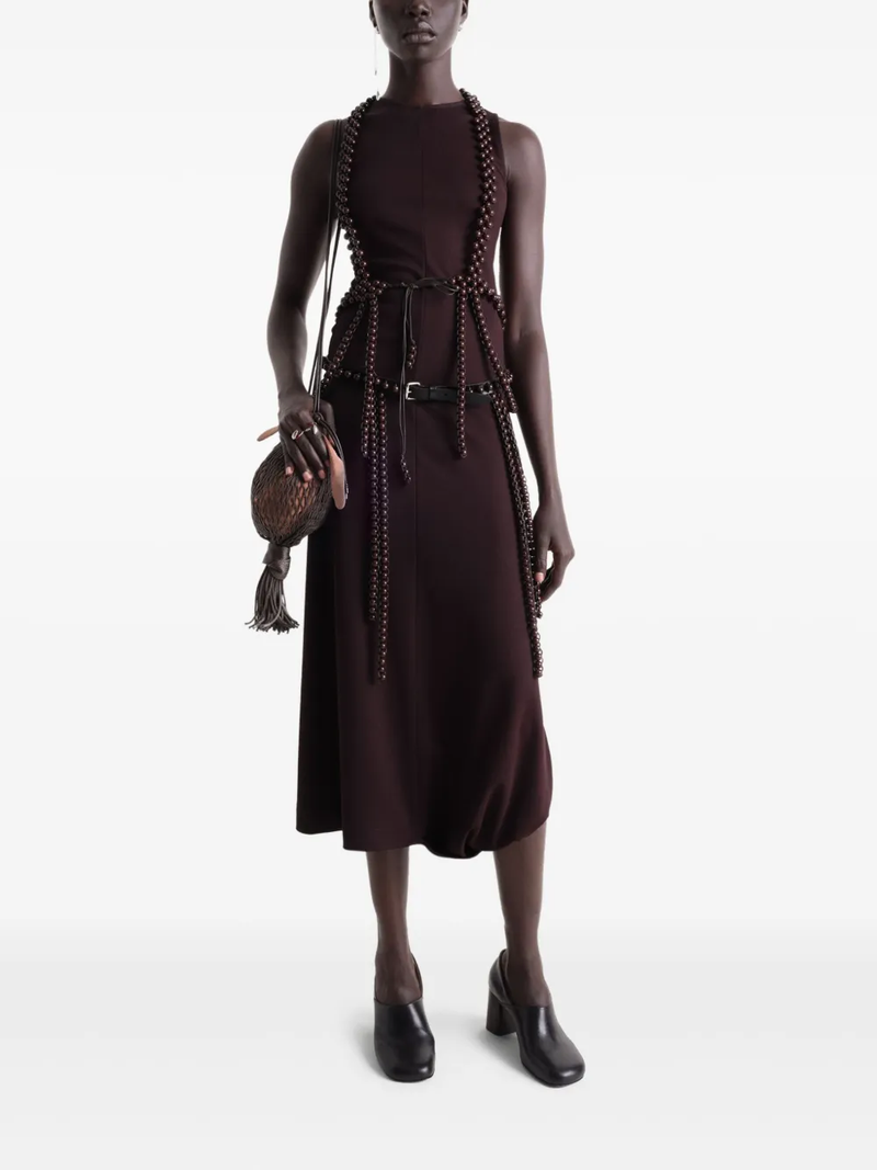 Burgundy dress worn by a person, showing the dress’ fit