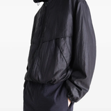 Black jacket worn by a person, showing the jacket fit