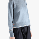 Blue pullover worn by a person, showing the pullover's fit