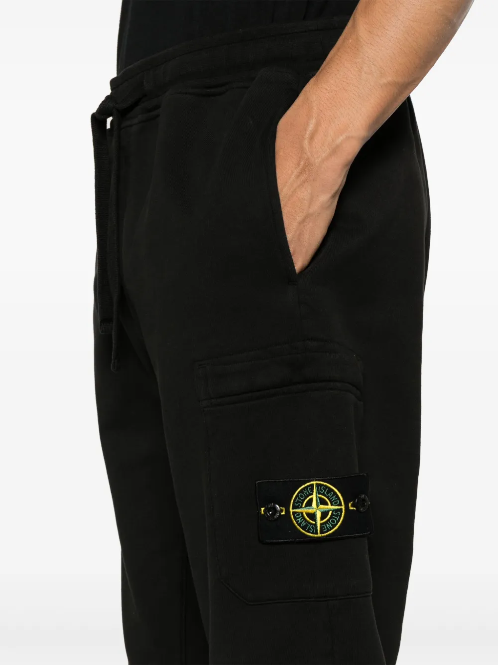 Black pants worn by a person, showing the pants fit