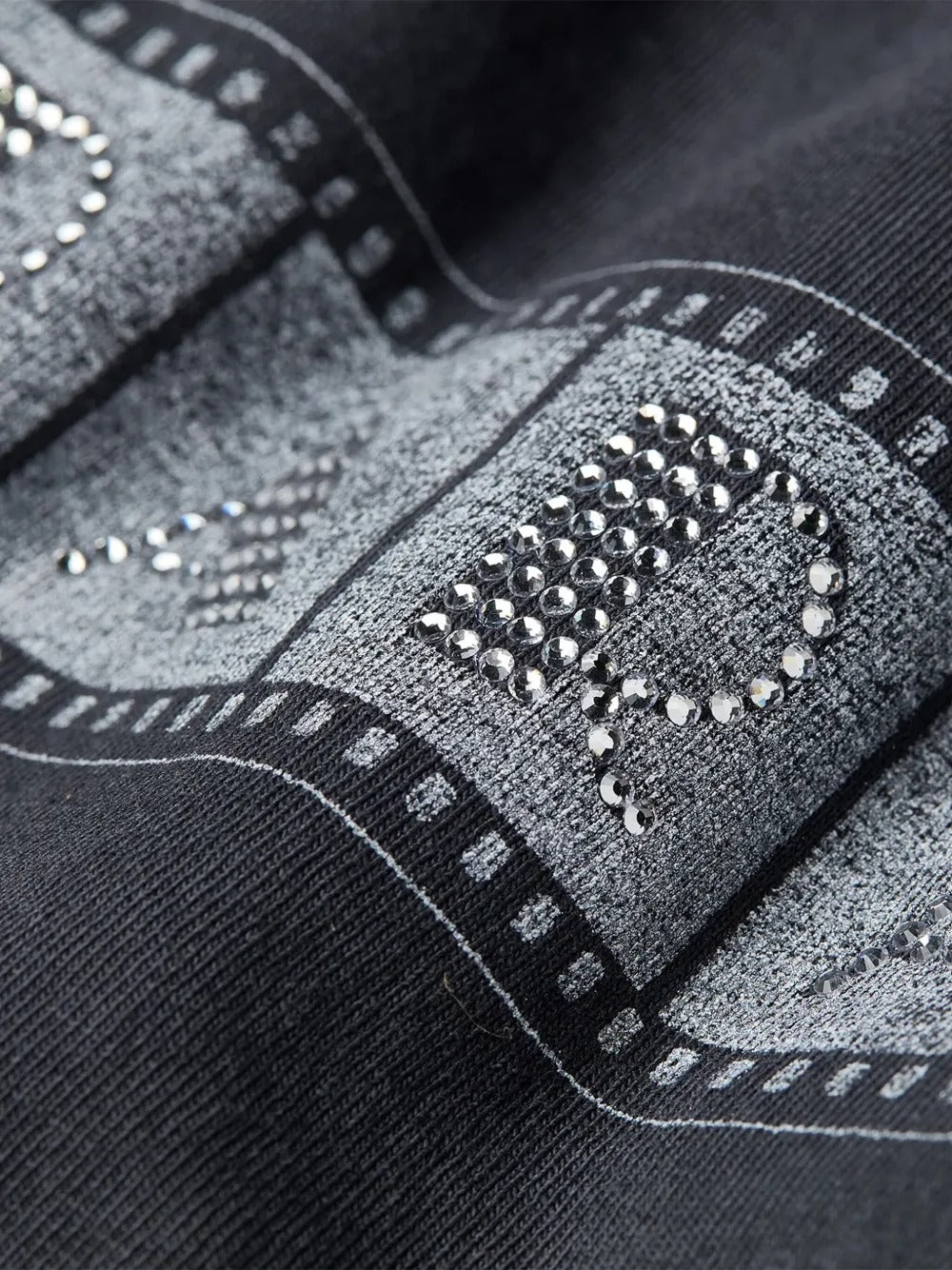 Close-up of black t-shirts, showing the texture of cotton fabric