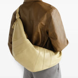 Tan bag worn by a person, showing the bag fit