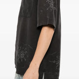 Black shirt worn by a person, showing the shirt fit