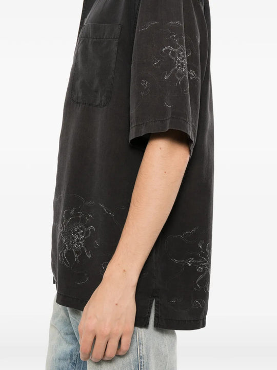 Black shirt worn by a person, showing the shirt fit