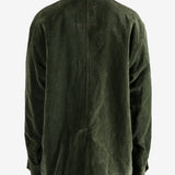 Green jacket worn by a person, showing the jacket's fit