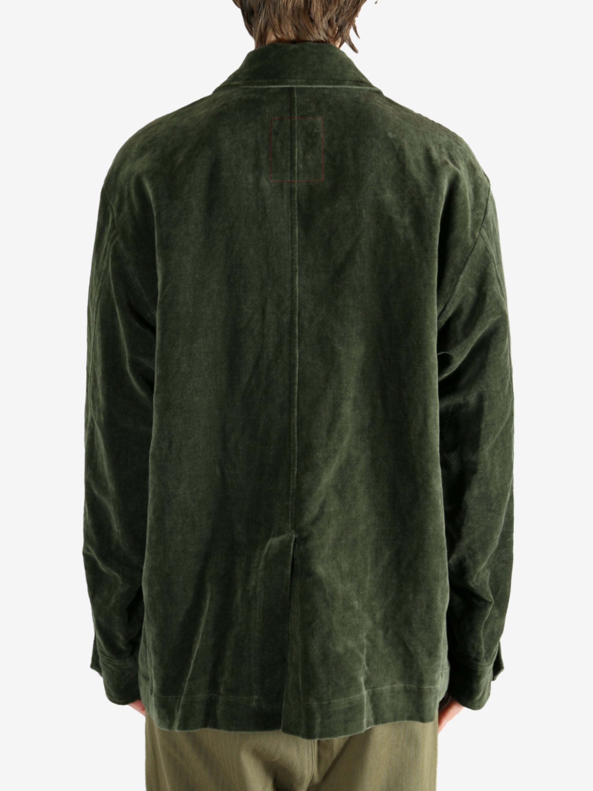 Green jacket worn by a person, showing the jacket's fit