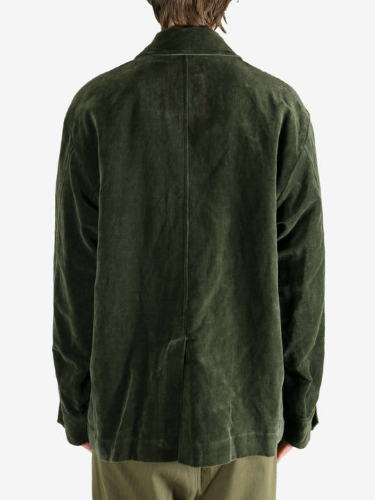 Green jacket worn by a person, showing the jacket's fit