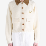 Tan knitwear worn by a person, showing the knitwear fit