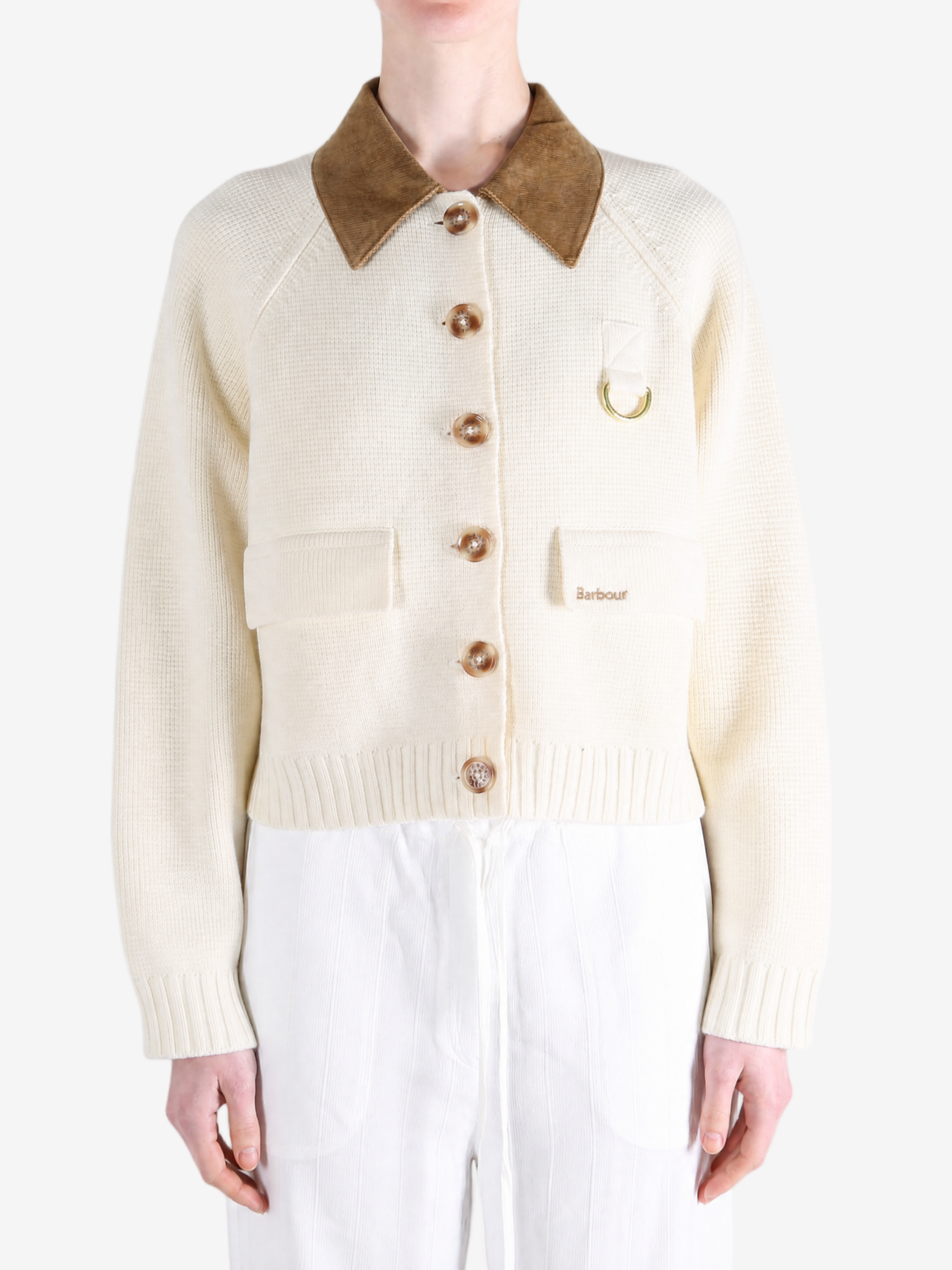 Tan knitwear worn by a person, showing the knitwear fit
