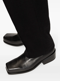 Close up of black boots,showing texture of the calf leather fabric.