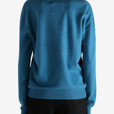 Blue sweater worn by a person, showing the sweater's fit
