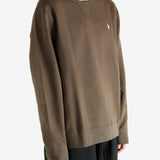 Brown knitwear worn by a person, showing the knitwear fit