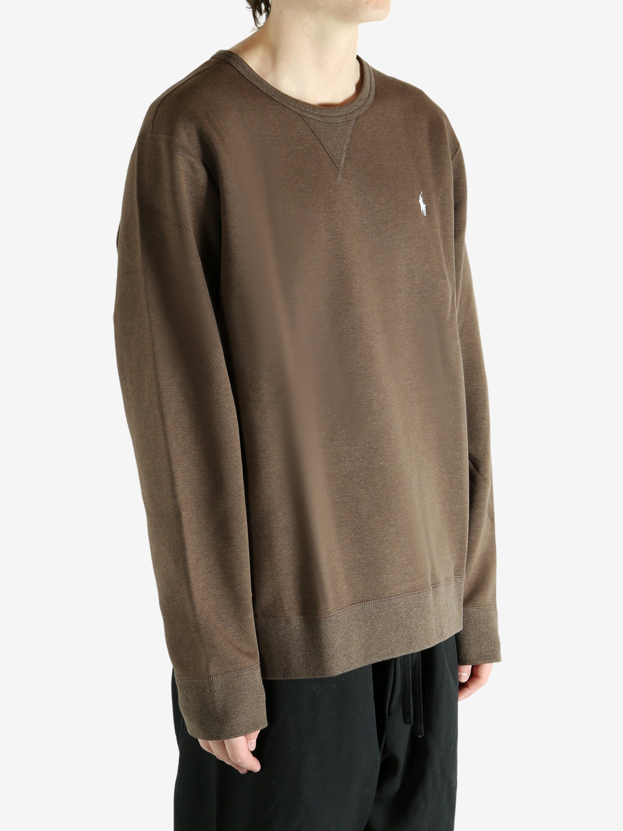 Brown knitwear worn by a person, showing the knitwear fit