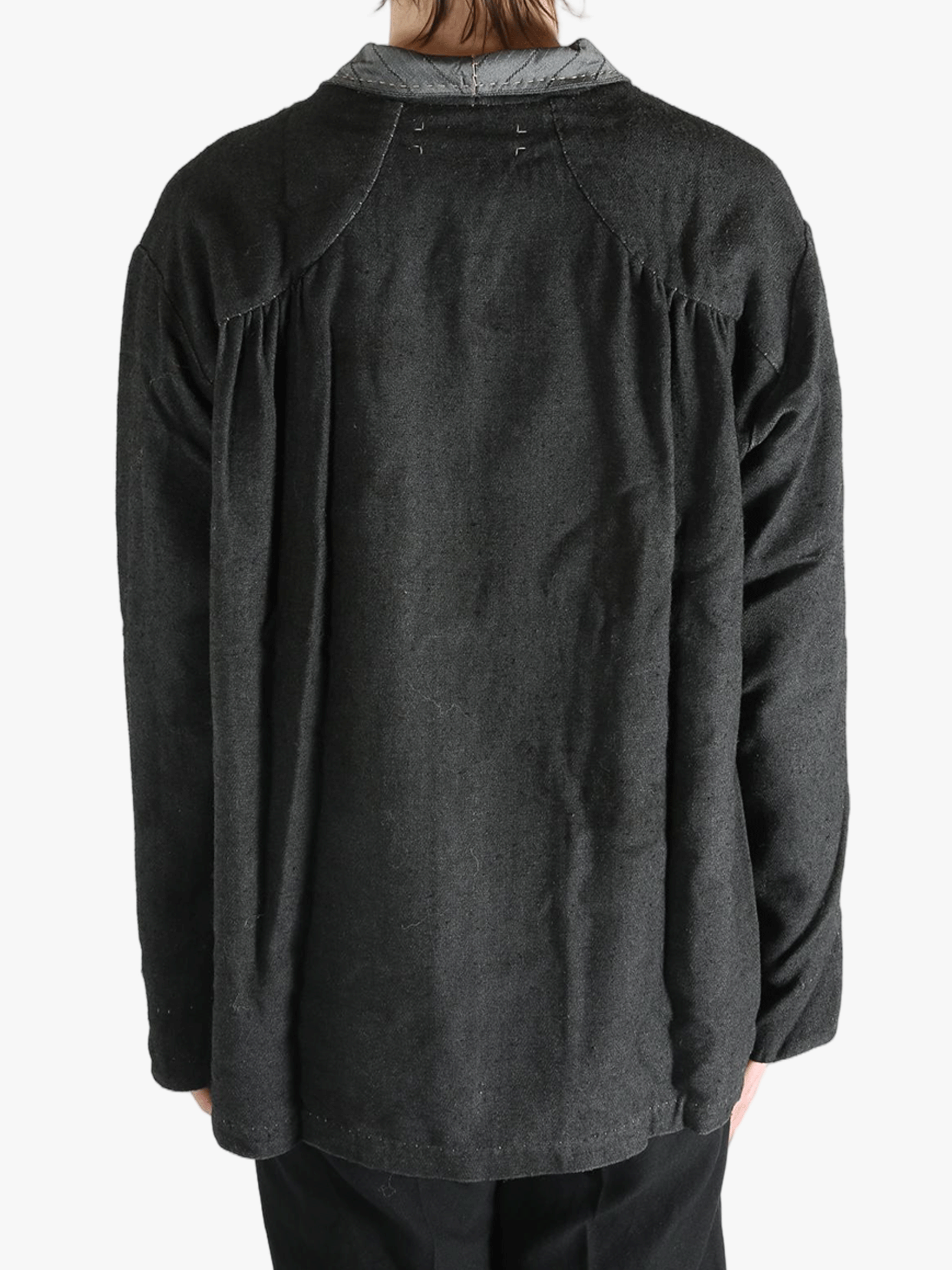 Grey shirts worn by a person, showing the shirts fit