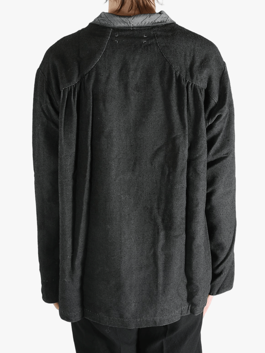 Grey shirts worn by a person, showing the shirts fit